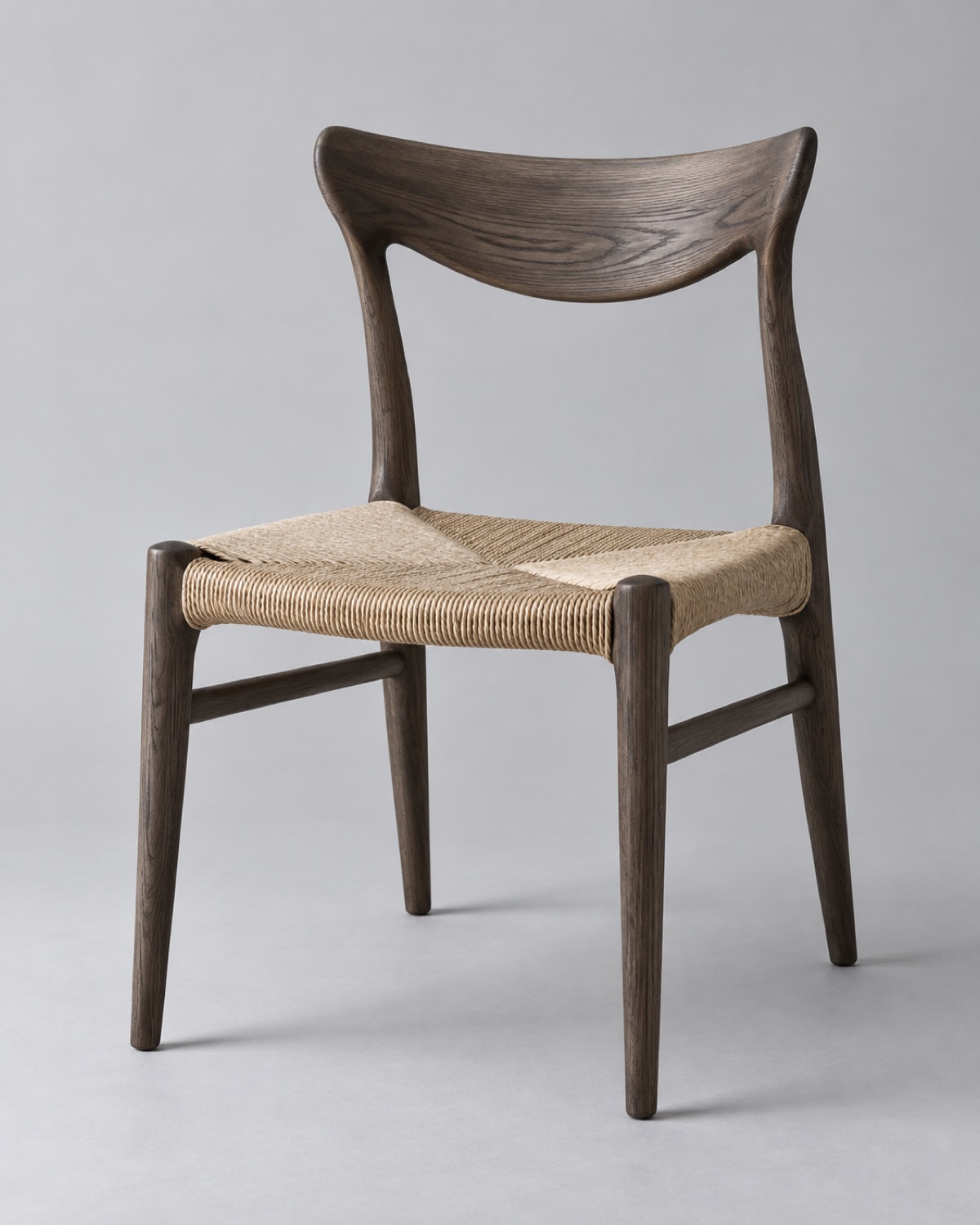 Smoked ash dining chair with a woven natural seat